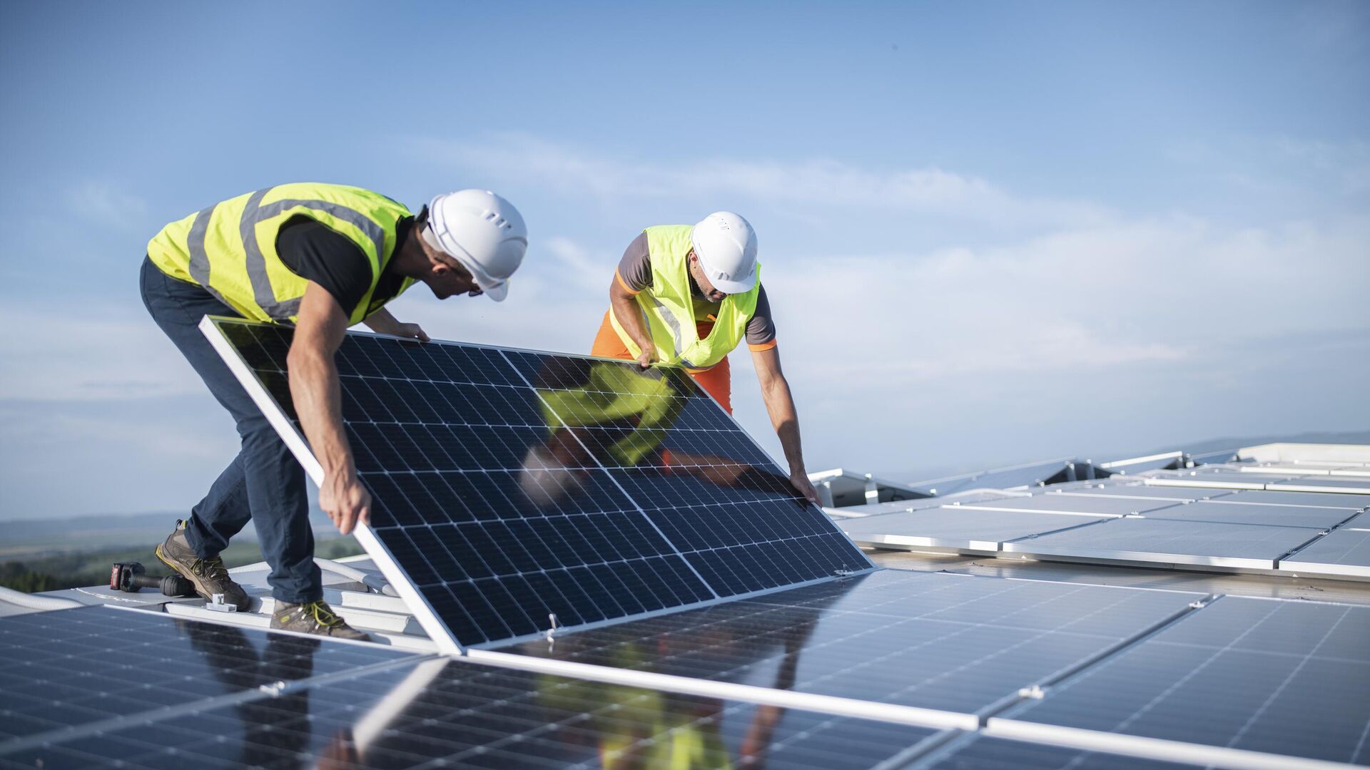 Commercial solar panel installation on a large building roof